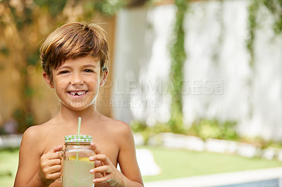 Buy stock photo Portrait of an adorable little boy drinking lemonade next to a swimming pool