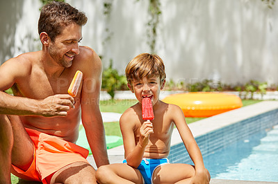 Buy stock photo Shot of a young man and his adorable son eating ice cream by the swimming pool