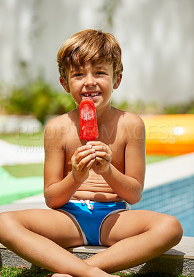 Buy stock photo Portrait of an adorable little boy eating an ice cream next to a swimming pool
