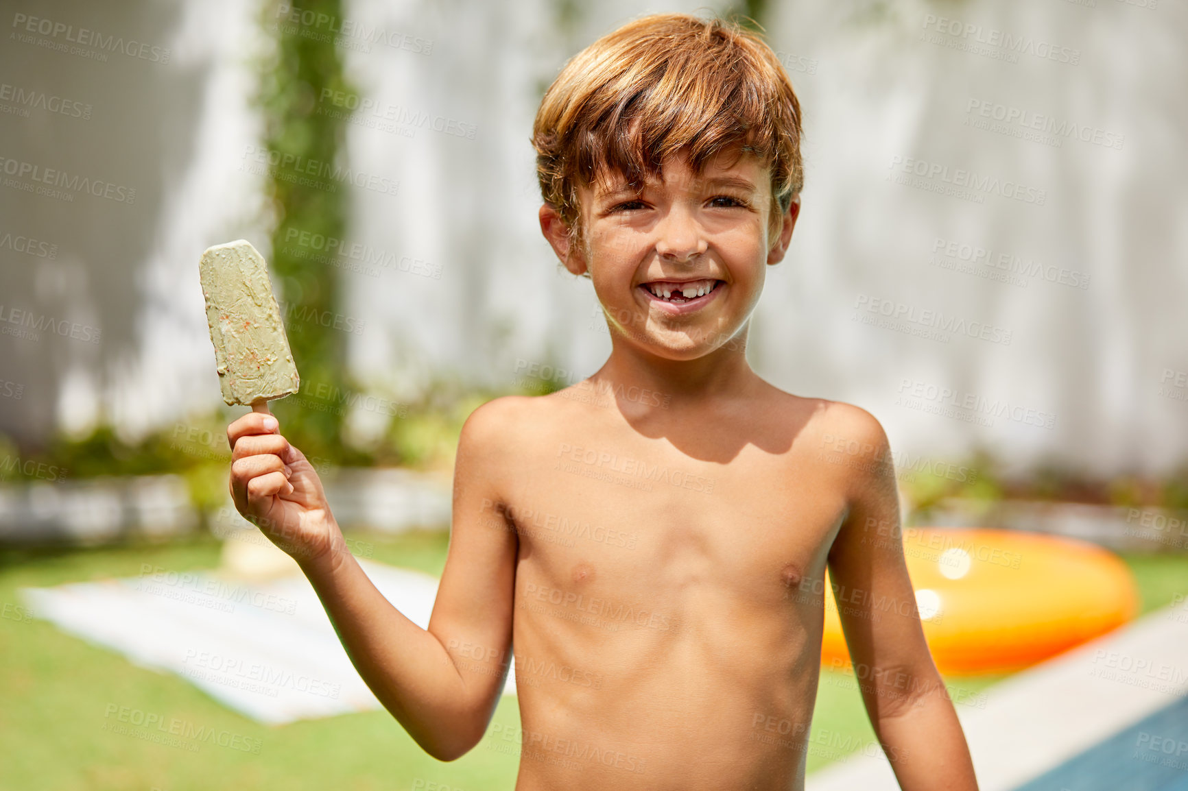 Buy stock photo Portrait of an adorable little boy eating an ice cream in the backyard on a summer's day