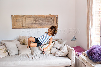 Buy stock photo Shot of a child having fun while jumping on a sofa