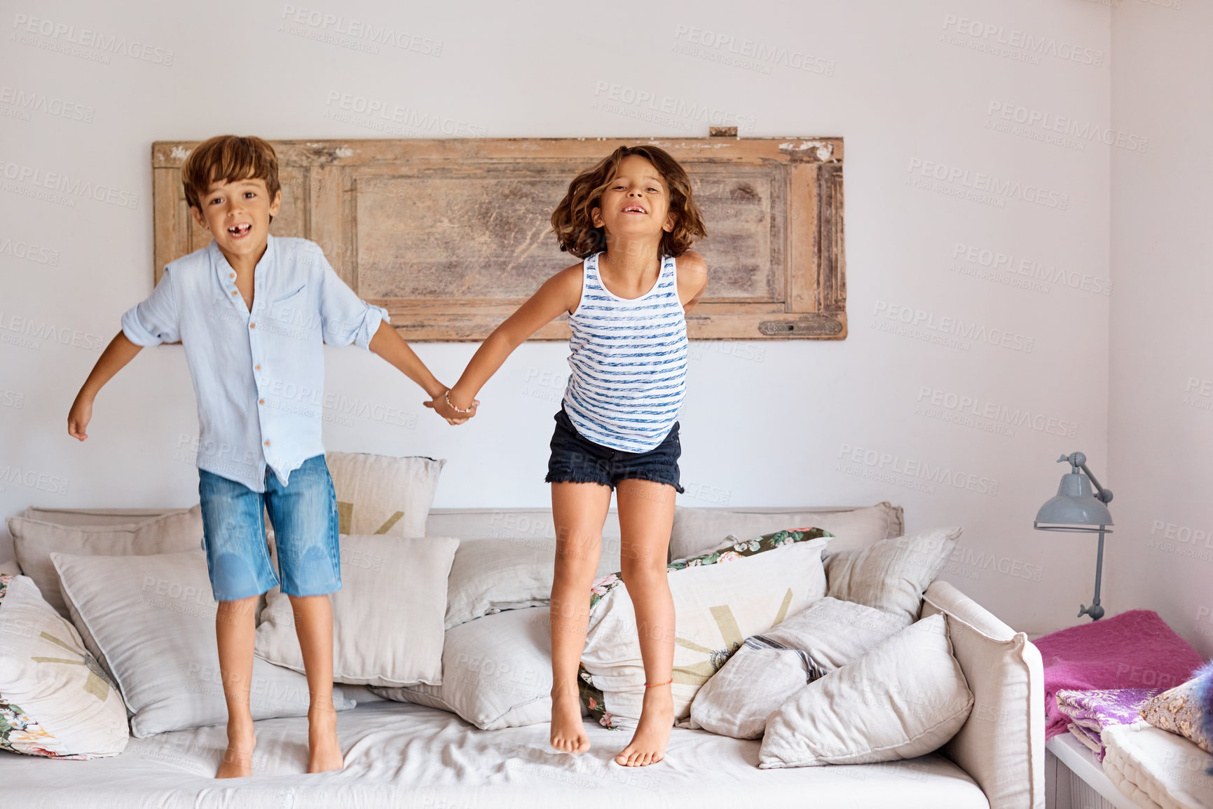 Buy stock photo Jumping, portrait and children on couch with holding hands, fun moment or bonding on weekend break. Happy, siblings and kids on sofa with energy, family relationship and playful connection in home.