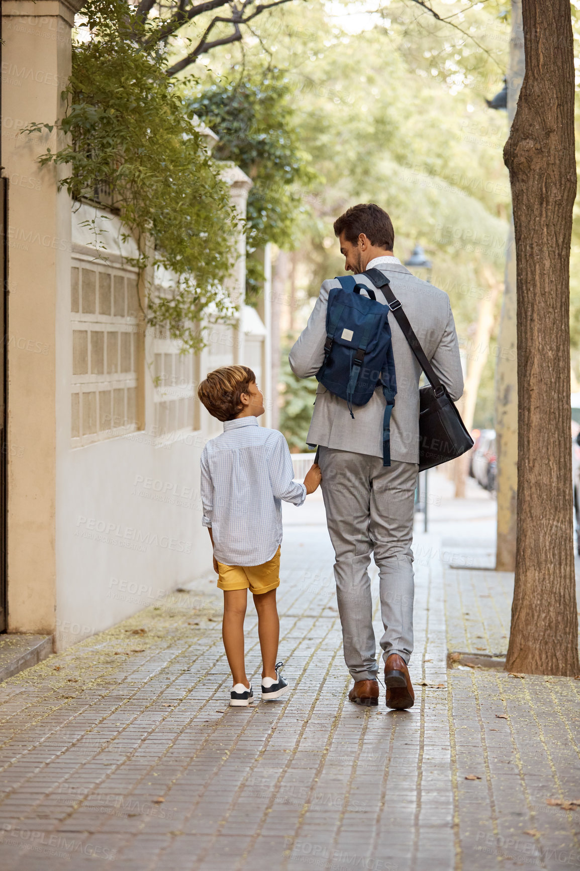 Buy stock photo Shot of a businessman walking his son to school