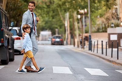 Buy stock photo Shot of a businessman walking his son to school
