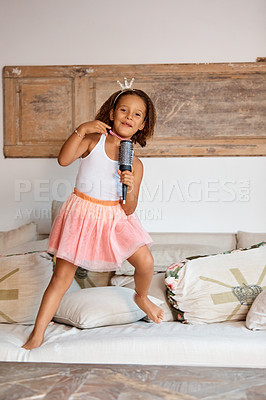 Buy stock photo Shot of a little girl playing karaoke with a hairbrush at home