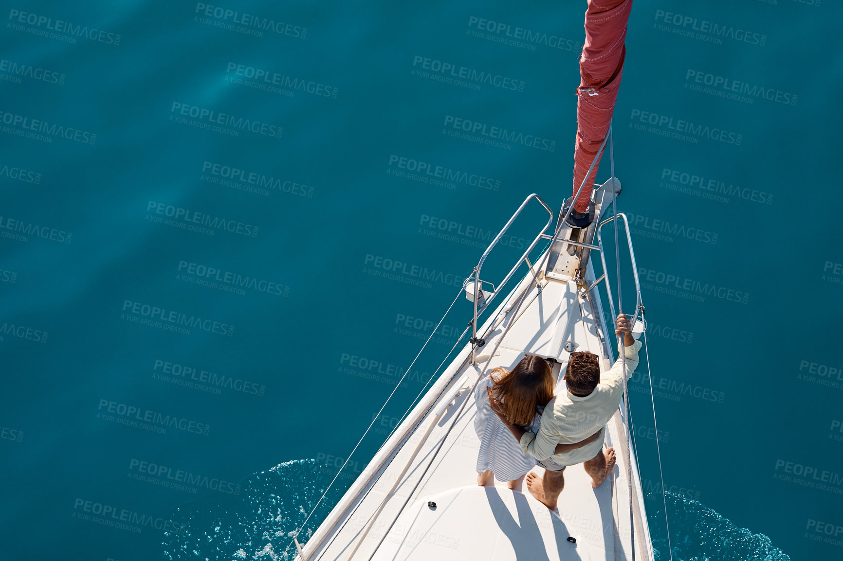 Buy stock photo High angle shot of an affectionate young couple enjoying a yacht cruise