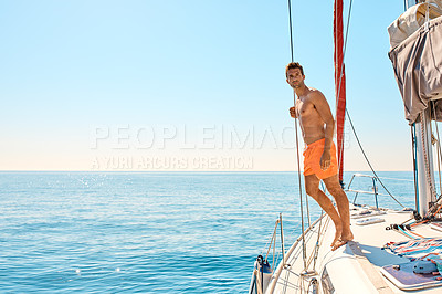 Buy stock photo Full length shot of a handsome young man checking out the view while enjoying a yacht cruise