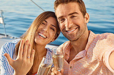 Buy stock photo Shot of a happy young couple getting engaged on an ocean cruise
