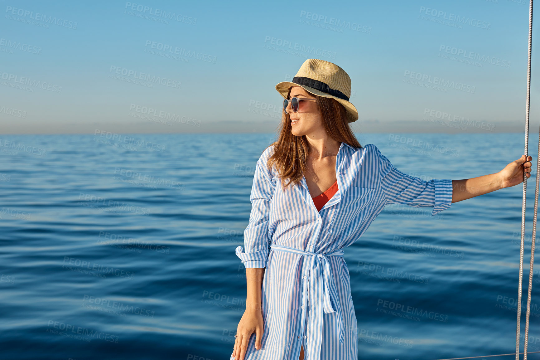 Buy stock photo Shot of a beautiful young woman going for an ocean cruise on a boat