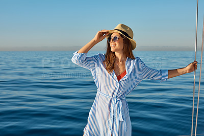 Buy stock photo Shot of a beautiful young woman going for an ocean cruise on a boat