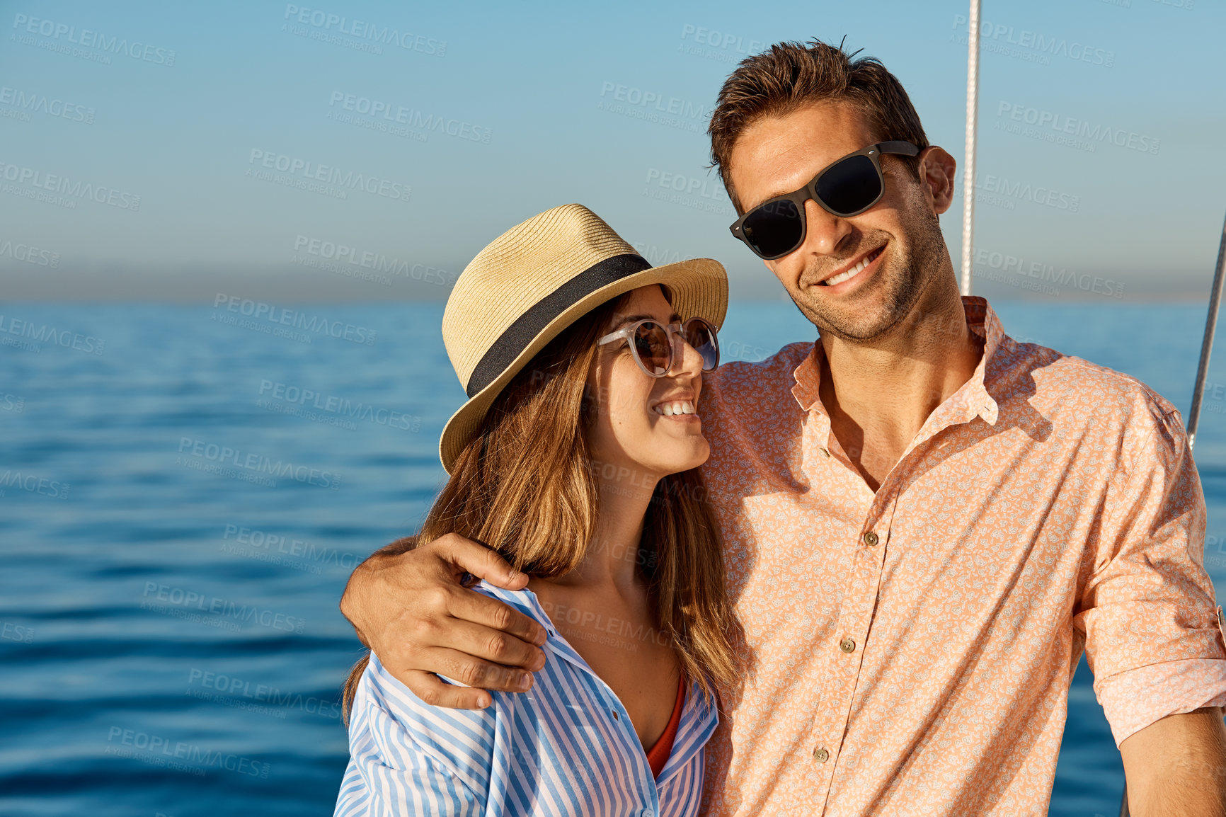 Buy stock photo Happy, couple and yacht on ocean with hug, sunglasses or love for bonding together on summer holiday. People, smile and embrace outdoor at sea with boat cruise, romantic getaway or travel with shades