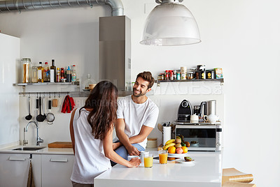 Buy stock photo Shot of a young couple having a relaxing breakfast together at home