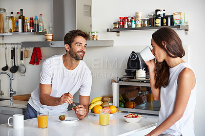 Buy stock photo Shot of a young couple having a relaxing breakfast together at home