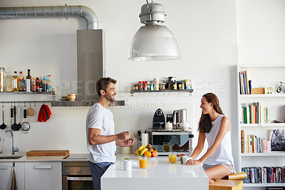 Buy stock photo Shot of a young couple having a relaxing breakfast together at home