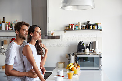 Buy stock photo Shot of a young couple having a relaxing breakfast together at home