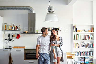 Buy stock photo Shot of a young couple spending time together in the morning at home