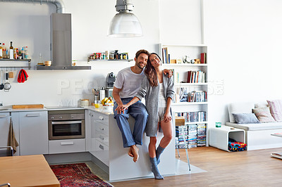 Buy stock photo Shot of a young couple spending time together in the morning at home