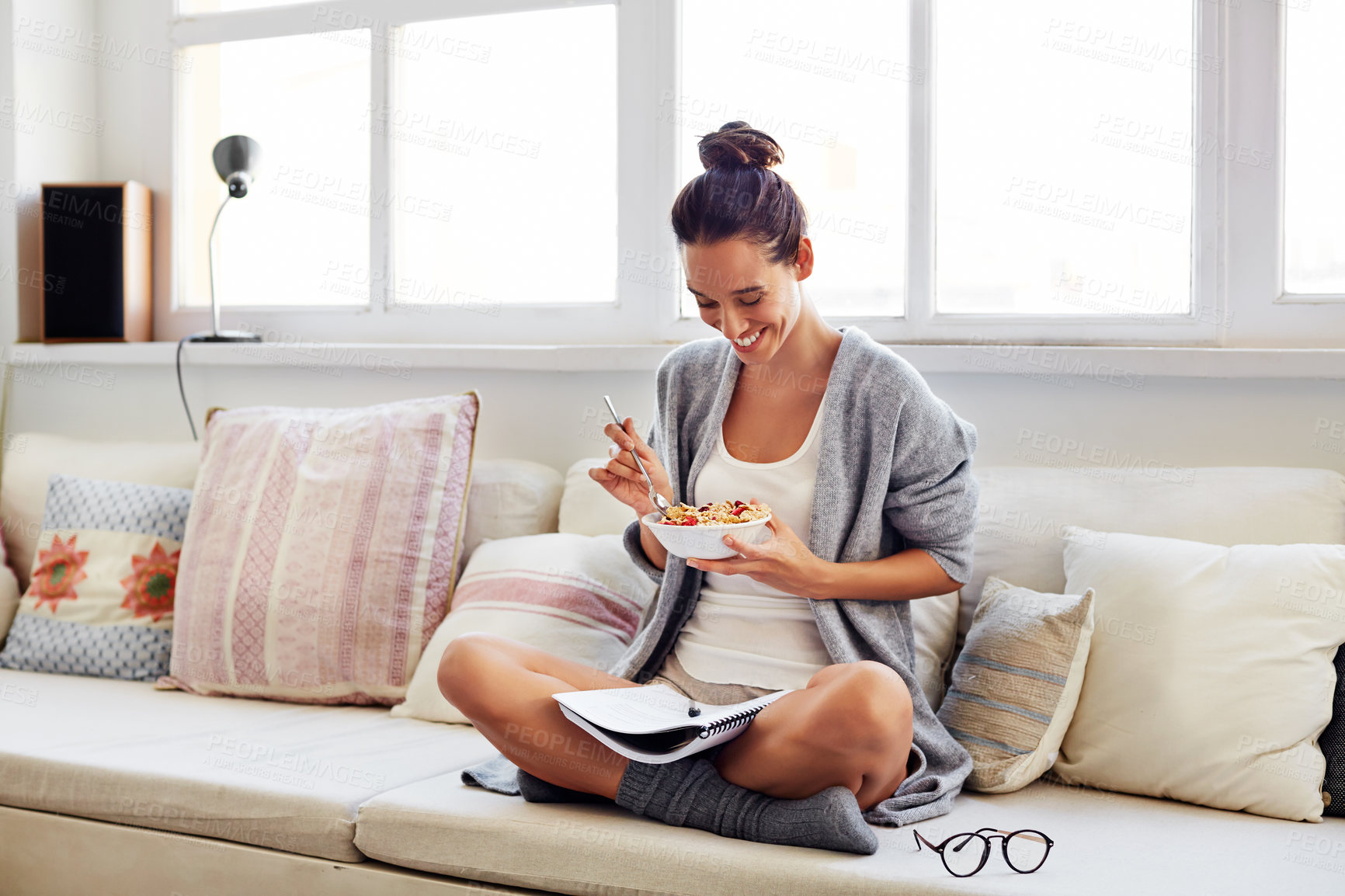 Buy stock photo Breakfast, home and happy woman with document for freelance budget, finance and proposal report. Sofa, eating cereal or person with paper for remote work, accounting or reading info with morning food