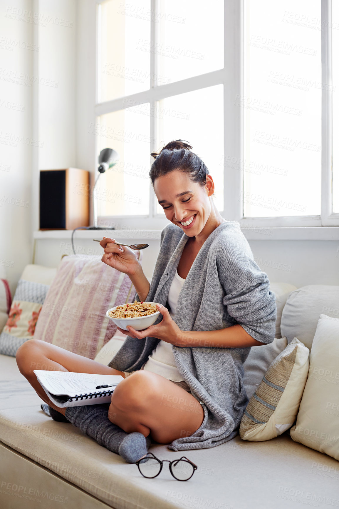 Buy stock photo Document, woman or smile in home with cereal, thesis study or breakfast for academic productivity. Happy, postgraduate and file for literature review, morning food and nutrition for student wellness