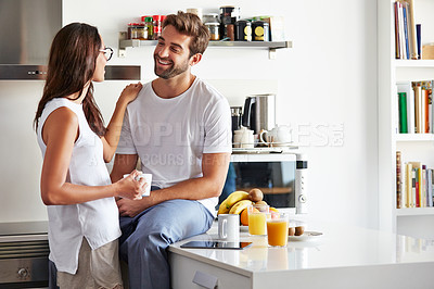 Buy stock photo Shot of a young couple having a relaxing breakfast together at home