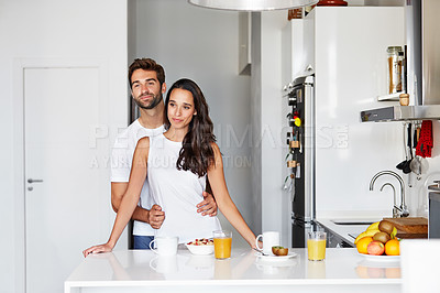 Buy stock photo Shot of a young couple having a relaxing breakfast together at home
