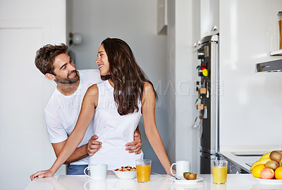 Buy stock photo Shot of a young couple having a relaxing breakfast together at home