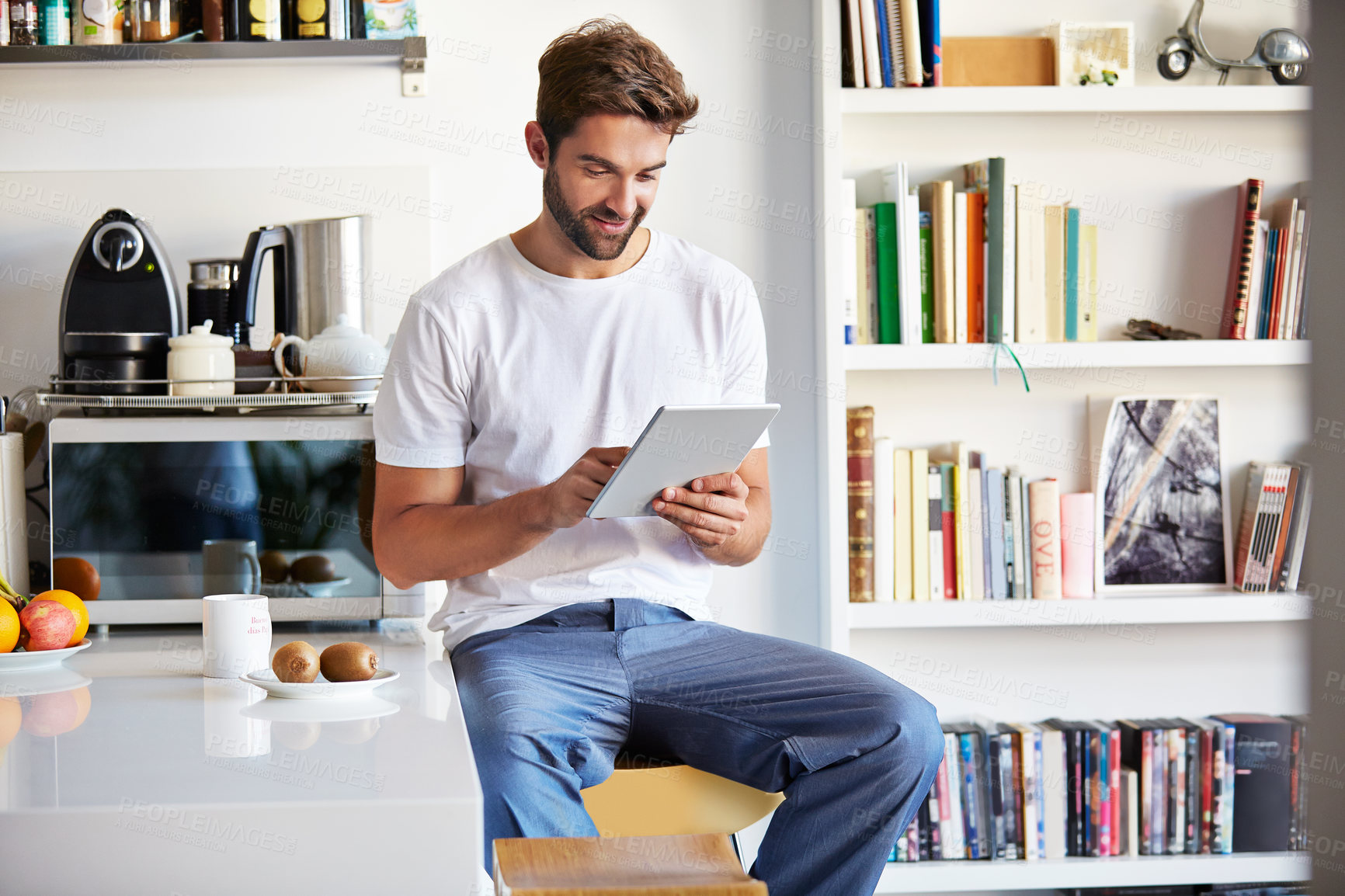 Buy stock photo Tablet, scroll and man in kitchen with smile, communication or social media post in home. Morning break, digital tech and person with reading blog for ebook, online dating app or chatting in house