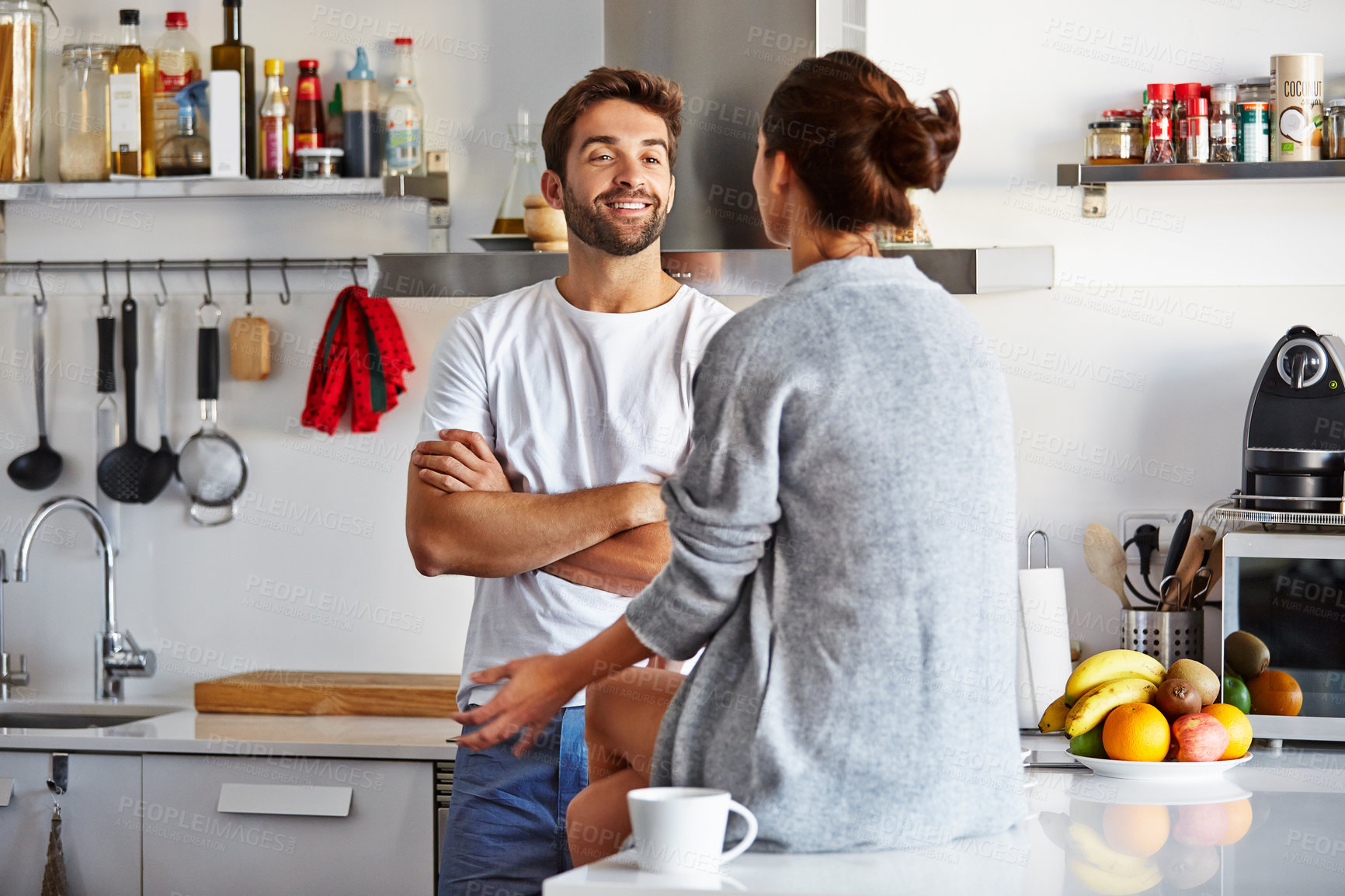 Buy stock photo Happy, couple and conversation in kitchen for morning discussion, chat or bonding together in home. Man, woman or talking with smile, breakfast or routine for weekend off or holiday break in house