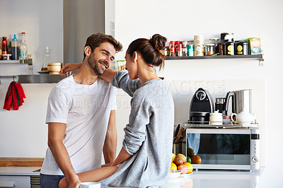 Buy stock photo Shot of an affectionate young couple spending time together in the morning at home