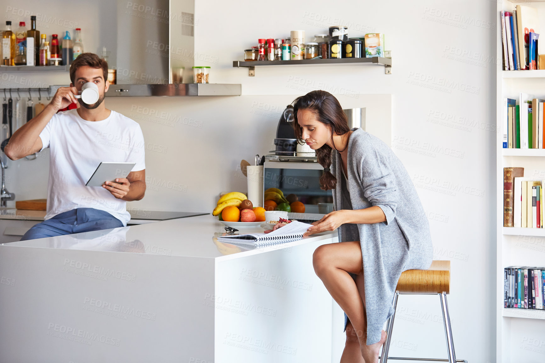 Buy stock photo Shot of a young couple going through their morning routine together at home