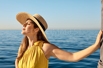 Buy stock photo Shot of a beautiful young woman going for an ocean cruise on a boat