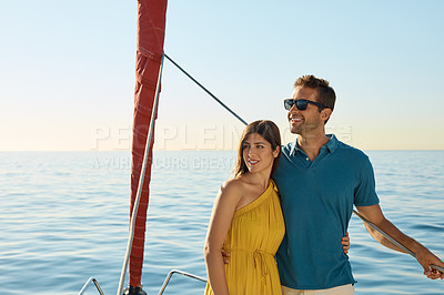 Buy stock photo Shot of a young couple enjoying a cruise out on the ocean