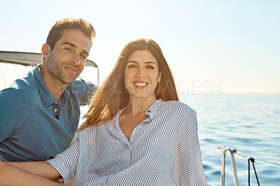 Buy stock photo Shot of a young couple enjoying a cruise out on the ocean