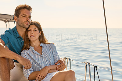 Buy stock photo Shot of a young couple enjoying a cruise out on the ocean