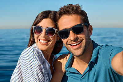 Buy stock photo Shot of a young couple taking a selfie together on an ocean cruise
