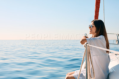 Buy stock photo Shot of a beautiful young woman going for an ocean cruise on a boat