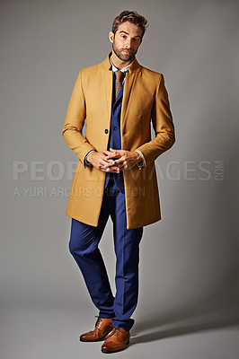 Buy stock photo Studio portrait of a handsome young businessman posing against a dark background