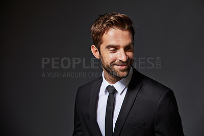 Buy stock photo Cropped shot of a handsome young businessman standing against a grey background