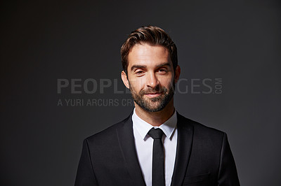 Buy stock photo Cropped portrait of a handsome young businessman standing against a grey background