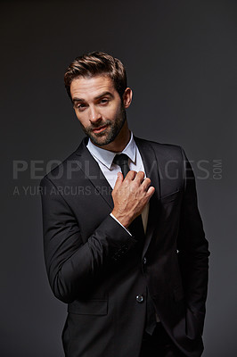 Buy stock photo Cropped portrait of a handsome young businessman standing against a grey background