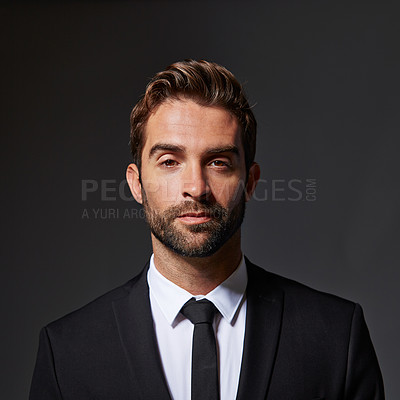 Buy stock photo Cropped portrait of a handsome young businessman standing against a grey background