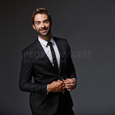 Buy stock photo Cropped portrait of a handsome young businessman standing against a grey background