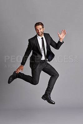 Buy stock photo Studio portrait of a handsome young man posing against a grey background