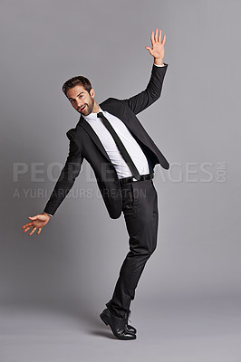 Buy stock photo Studio portrait of a handsome young man posing against a grey background