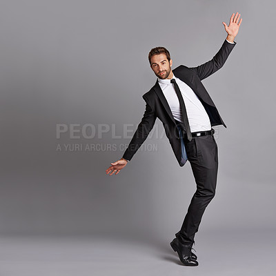 Buy stock photo Studio portrait of a handsome young man posing against a grey background