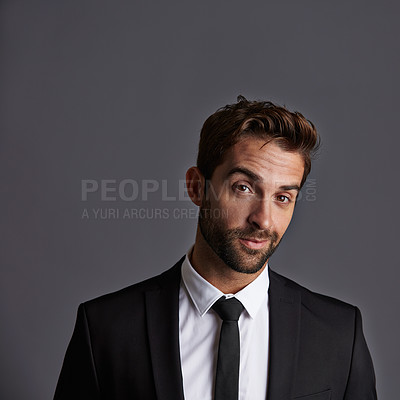Buy stock photo Studio portrait of a handsome young businessman posing against a grey background