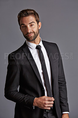 Buy stock photo Studio portrait of a handsome young businessman posing against a grey background