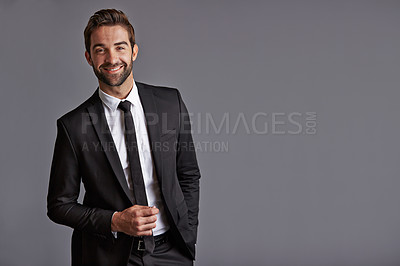 Buy stock photo Studio portrait of a handsome young businessman posing against a grey background