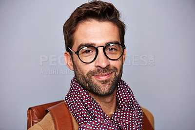 Buy stock photo Studio portrait of a handsome young man posing against a grey background