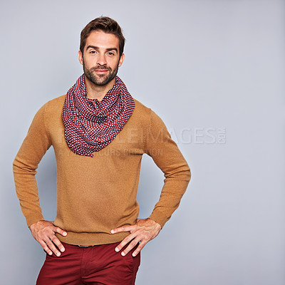Buy stock photo Studio portrait of a handsome young man standing with his hands on his hips against a grey background